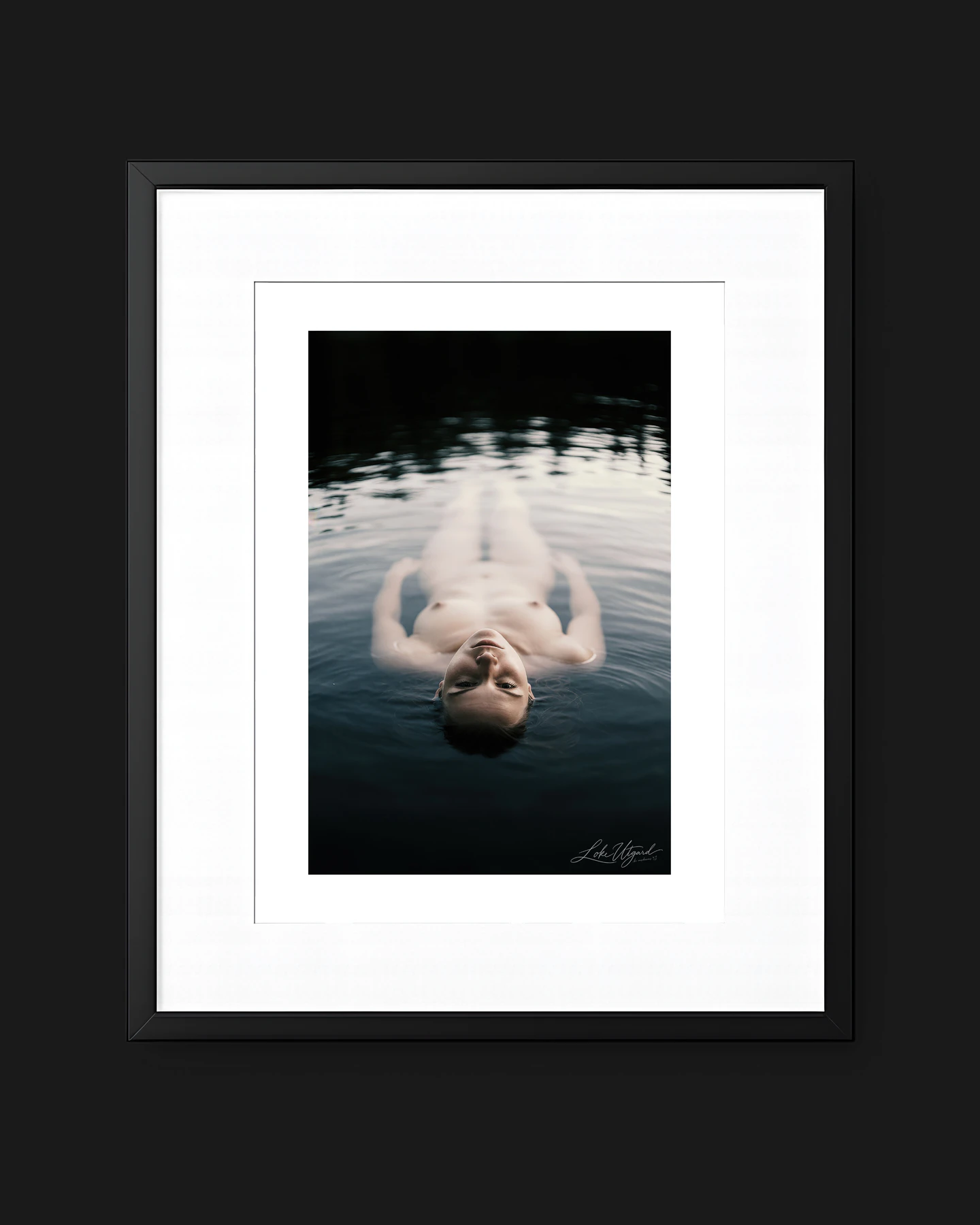 Framed collector edition titled Floating, showing a figure floating face-up in dark water