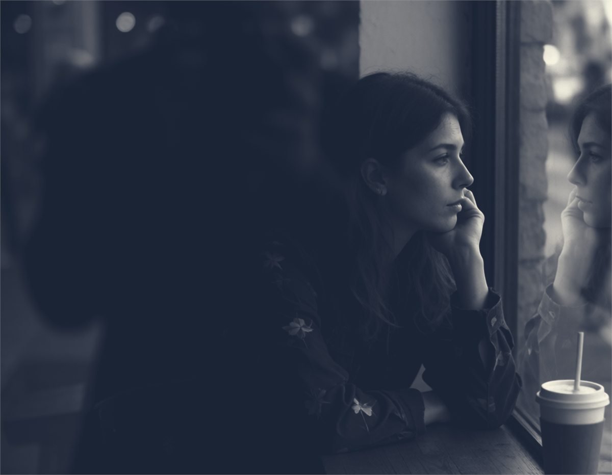 A model seated beside a window